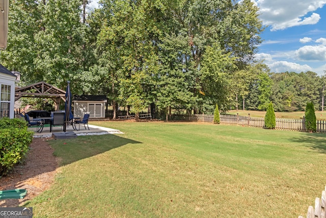 view of yard with a shed, a gazebo, and a patio area