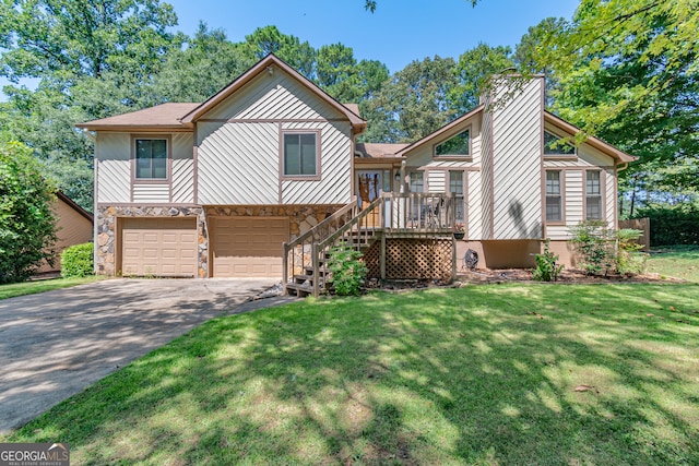 view of front of house with a front yard, a garage, and a deck