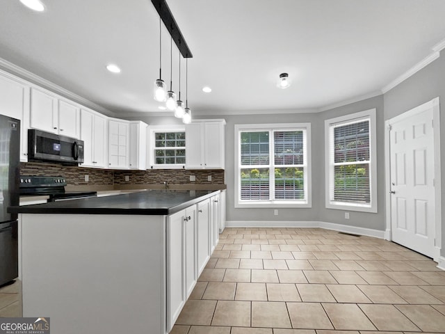 305 Crest Pointe S, Bremen, GA 30110 - kitchen featuring stainless steel microwave, black range with electric cooktop, crown molding, dark countertops, and backsplash
