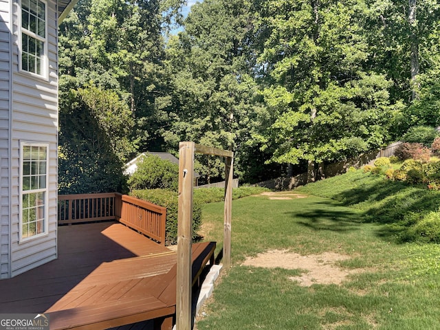 view of yard featuring fence and a wooden deck