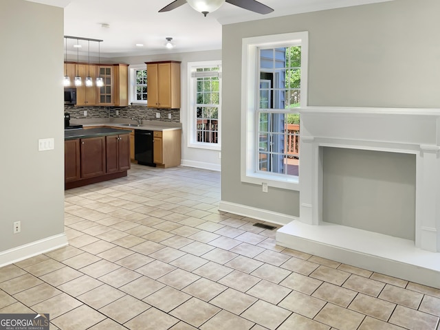 kitchen featuring glass insert cabinets, pendant lighting, brown cabinetry, and dishwasher