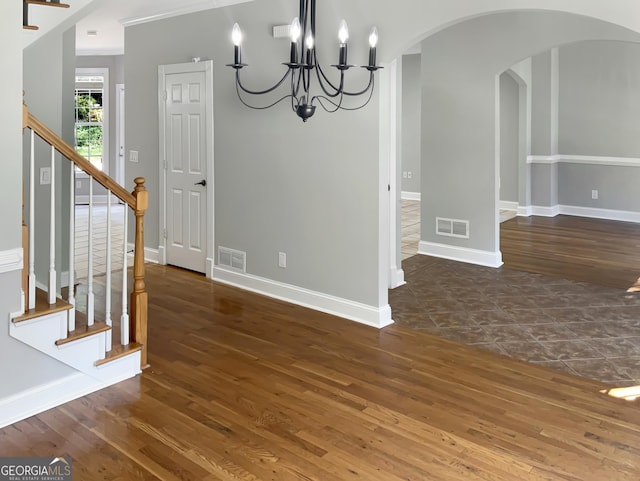 unfurnished dining area with stairway, visible vents, and arched walkways