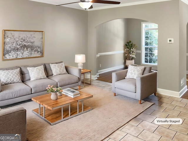 305 Crest Pointe S, Bremen, GA 30110 - living area with arched walkways, a ceiling fan, crown molding, baseboards, and light tile patterned floors