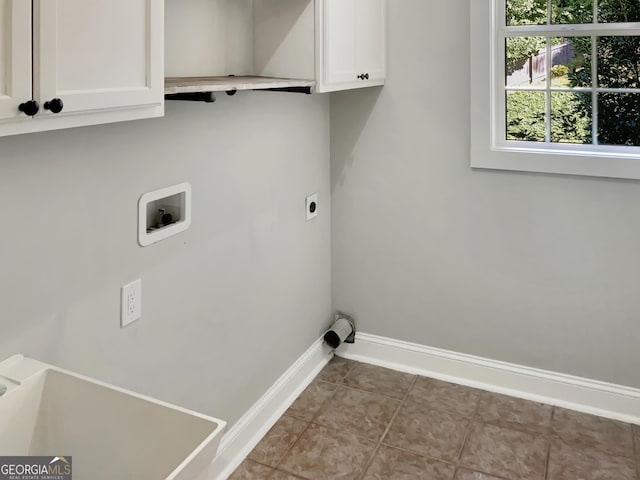 laundry room featuring light tile patterned floors, hookup for a washing machine, hookup for an electric dryer, baseboards, and cabinet space