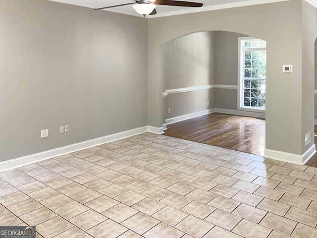 305 Crest Pointe S, Bremen, GA 30110 - empty room with ceiling fan, arched walkways, ornamental molding, baseboards, and light wood-style floors