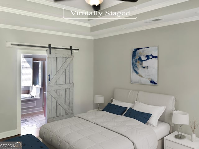 bedroom with a barn door, visible vents, and crown molding