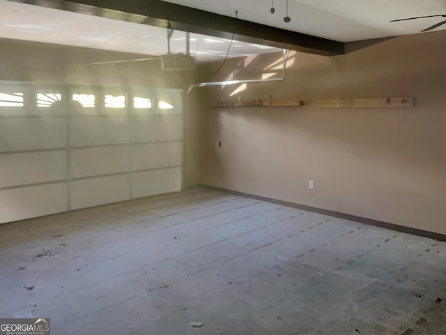 garage with baseboards and a garage door opener