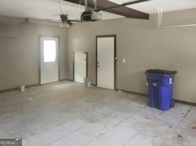 garage with baseboards and a garage door opener