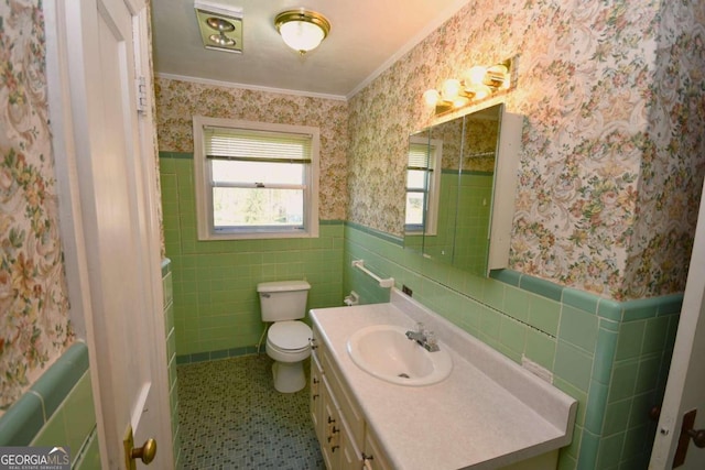 bathroom with decorative backsplash, vanity, tile patterned floors, tile walls, and toilet