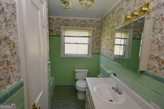 bathroom with tile walls, vanity, a healthy amount of sunlight, and toilet