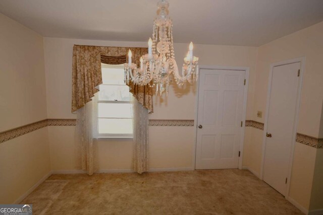 unfurnished dining area with light colored carpet and a chandelier