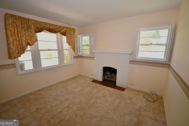 unfurnished living room featuring a fireplace and carpet floors