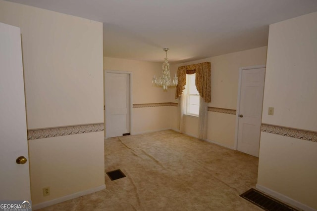 unfurnished dining area featuring an inviting chandelier and light colored carpet