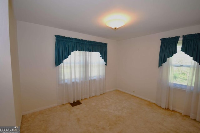 spare room with light colored carpet