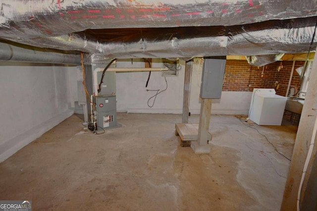 basement featuring washer / clothes dryer and heating unit