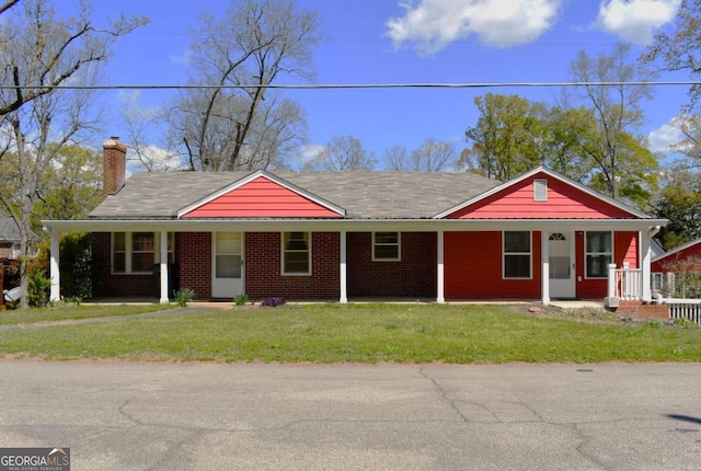 single story home featuring covered porch and a front lawn