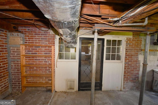 basement featuring brick wall