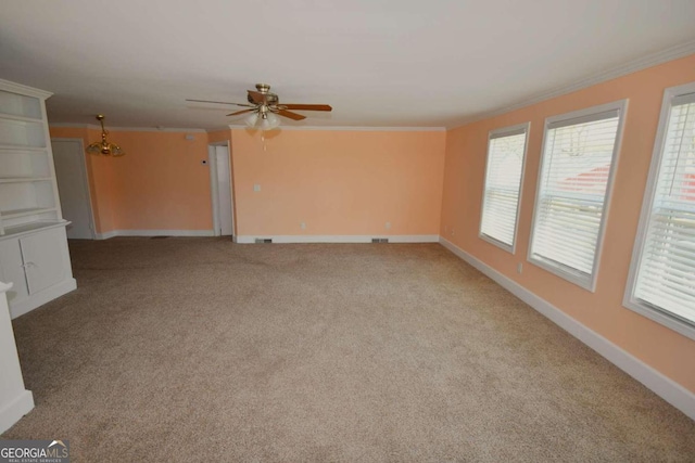 interior space featuring ceiling fan, ornamental molding, and light colored carpet