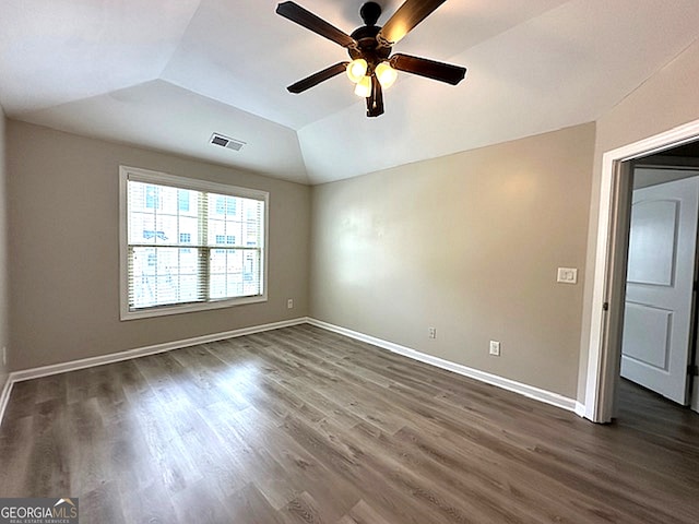 unfurnished room featuring ceiling fan, dark hardwood / wood-style flooring, and vaulted ceiling