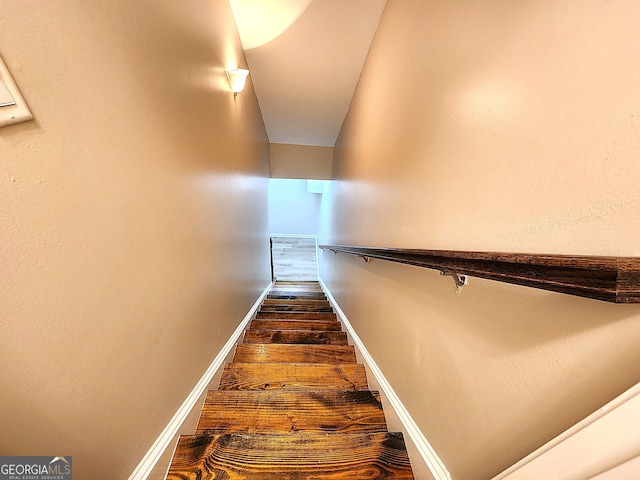 stairway with hardwood / wood-style flooring