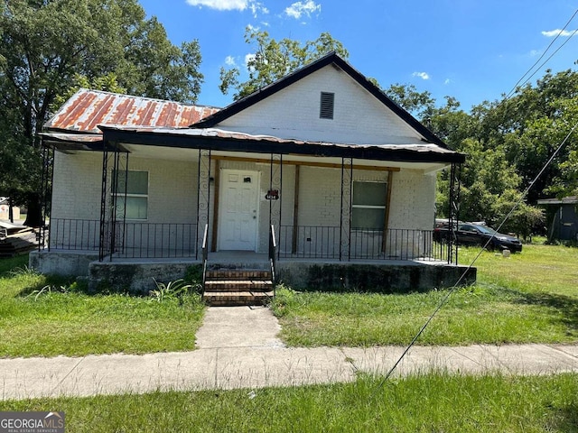 bungalow with a front lawn and a porch