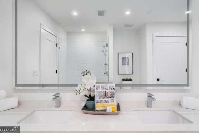 full bathroom with visible vents, a sink, and double vanity