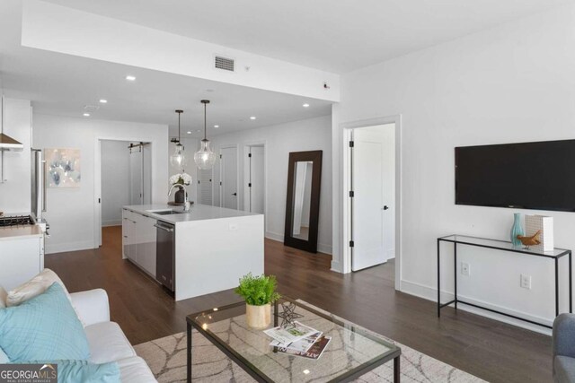 living room featuring dark hardwood / wood-style floors and sink