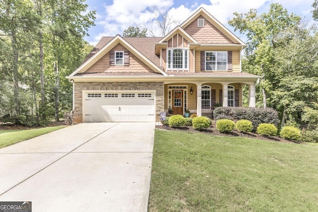 133 Oak Dr, Gray, GA 31032 - craftsman inspired home featuring driveway, covered porch, a front lawn, and an attached garage
