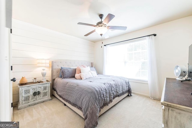 bedroom with ceiling fan and light carpet