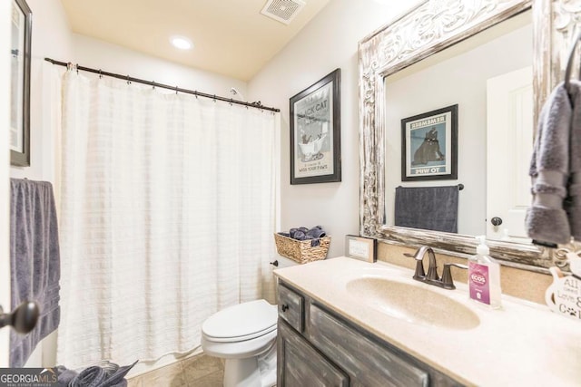 bathroom featuring toilet, vanity, a shower with shower curtain, and tile patterned flooring