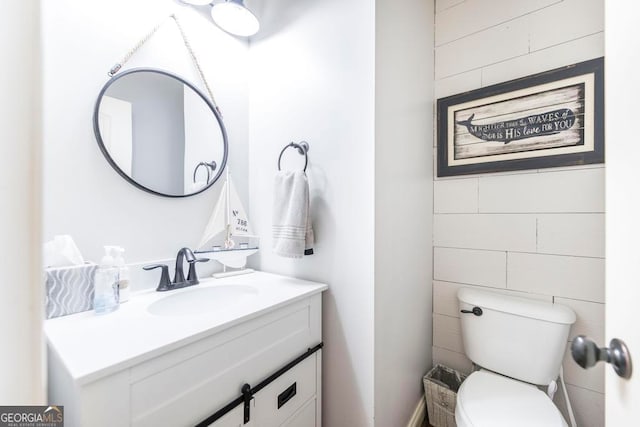 bathroom featuring toilet and vanity