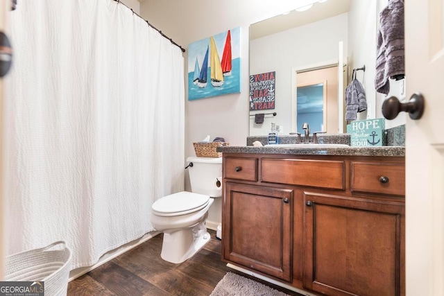 bathroom featuring vanity, toilet, wood-type flooring, and a shower with shower curtain