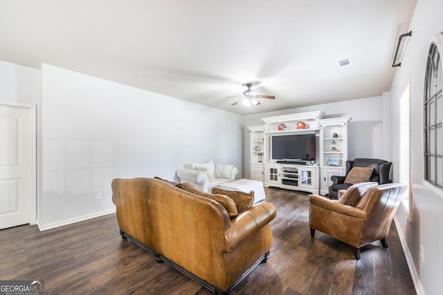 living room featuring ceiling fan and dark hardwood / wood-style flooring