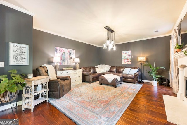 living room featuring ornamental molding, a notable chandelier, and dark hardwood / wood-style flooring