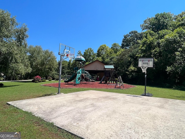 view of sport court featuring a playground and a lawn