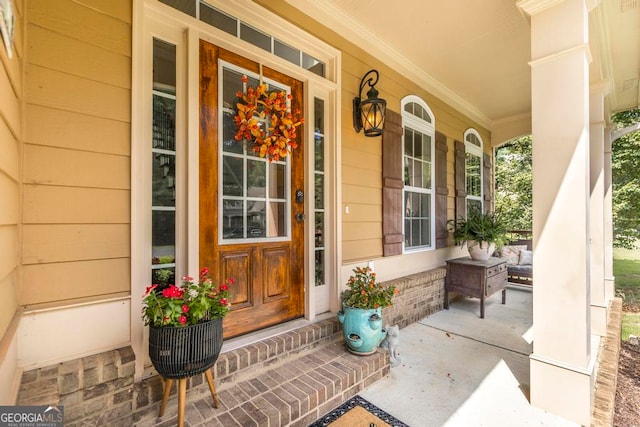 view of exterior entry with covered porch