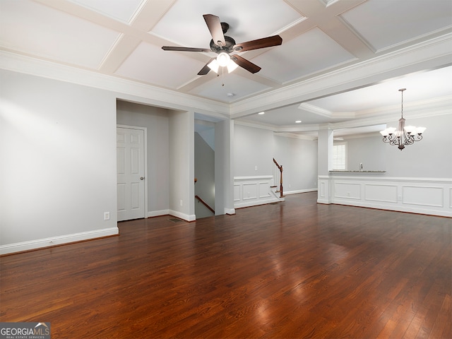 unfurnished living room featuring ceiling fan with notable chandelier, coffered ceiling, dark hardwood / wood-style flooring, and ornamental molding