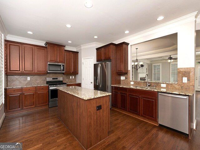 kitchen with hanging light fixtures, dark hardwood / wood-style floors, sink, and stainless steel appliances