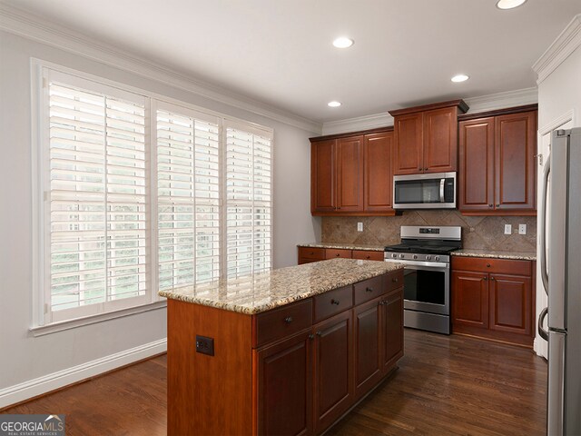 kitchen with crown molding, dark hardwood / wood-style flooring, stainless steel appliances, and light stone counters