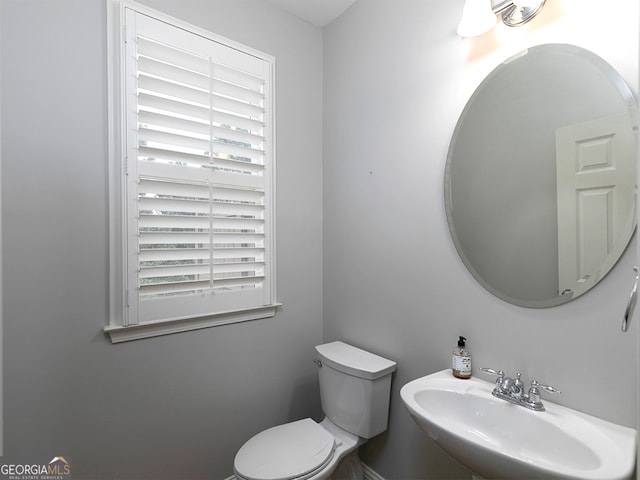 bathroom featuring sink, plenty of natural light, and toilet