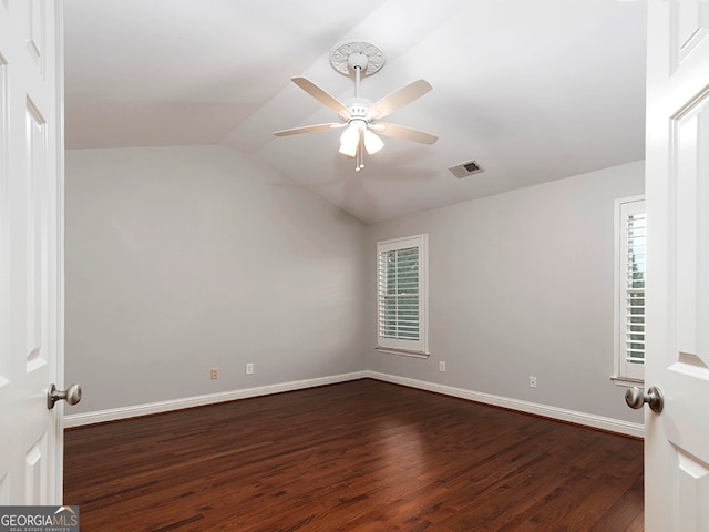 spare room with lofted ceiling, ceiling fan, and dark hardwood / wood-style floors