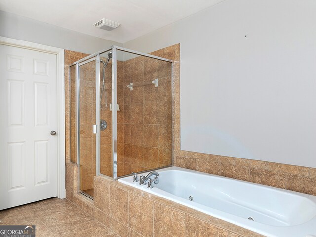 bathroom featuring independent shower and bath and tile patterned flooring