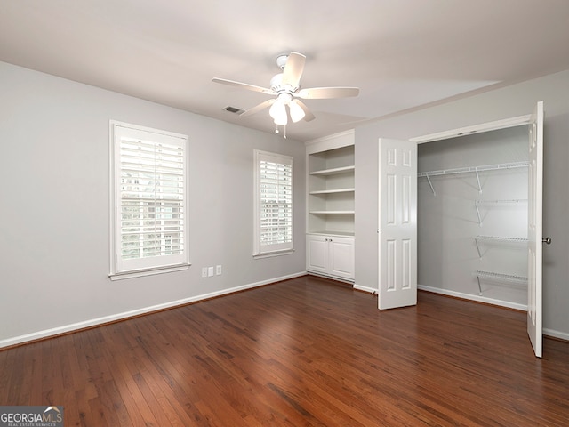 unfurnished bedroom with a closet, ceiling fan, and dark hardwood / wood-style floors