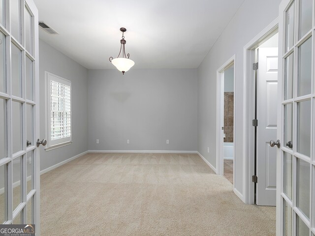 empty room with light carpet and french doors