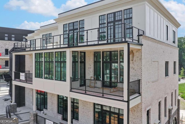 view of side of property with a balcony