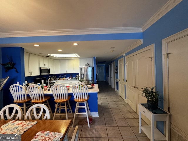 dining area with ornamental molding, recessed lighting, and tile patterned floors