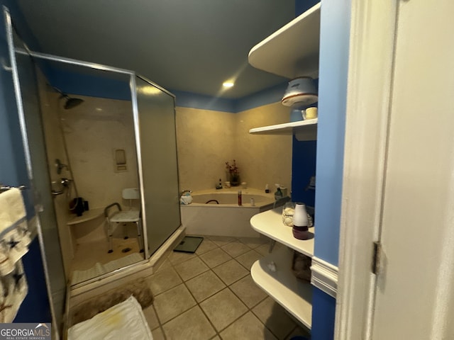 full bathroom featuring a stall shower, tile patterned flooring, and a garden tub