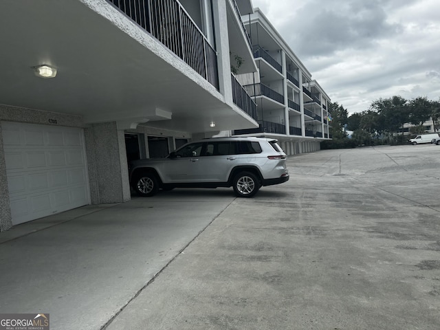 view of parking featuring an attached garage