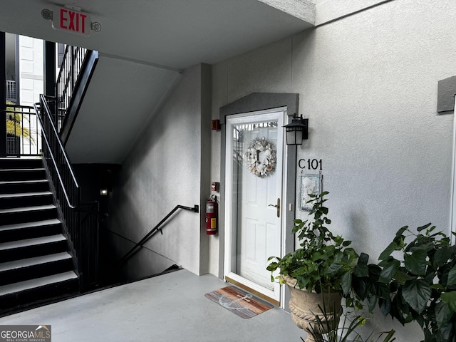 property entrance with stucco siding