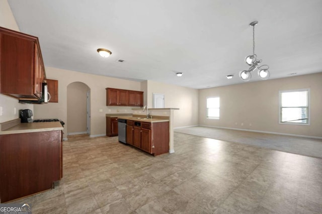 kitchen featuring light tile patterned flooring, a wealth of natural light, stainless steel appliances, and decorative light fixtures